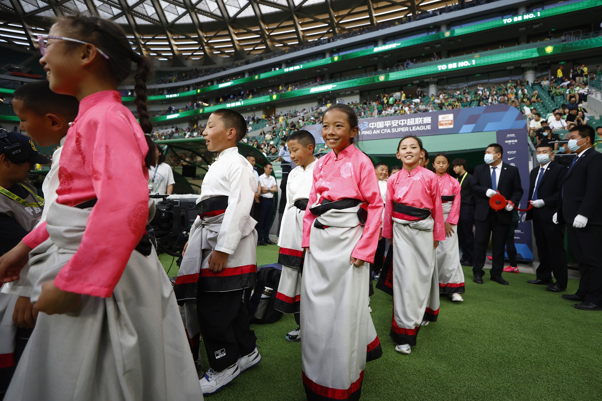 Tibetan teenagers watched a football game at the Beijing Workers